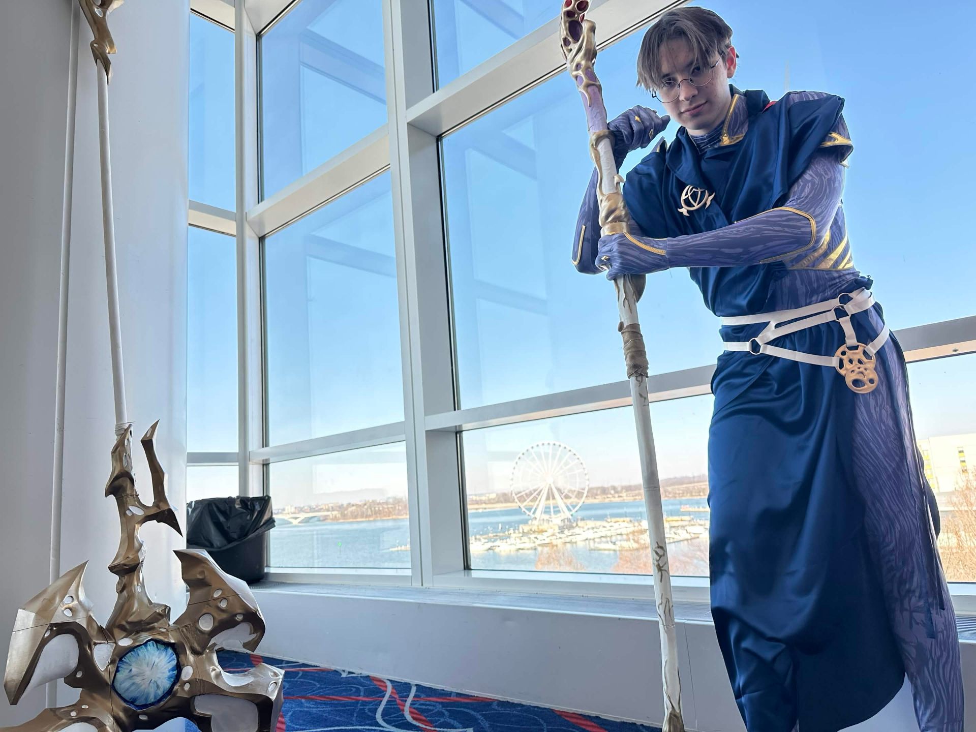 Alex in cosplay with hand-built staff and prop